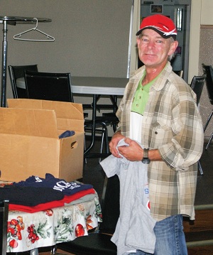 David Kiff, custodian at the Lighthouse Centre, sorts clothing for the drop-in program, which offers laundry and shower facilities. “This is the most fun and fulfilling job I have ever had,” he says.