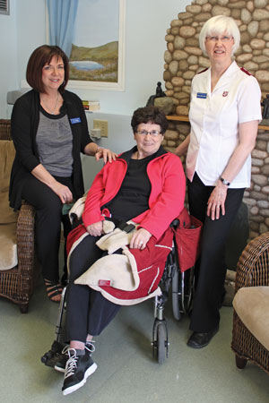 Ivy Scobie, Val Linder and Mjr Joanne Binner, former chaplain, share a moment together in one of the home's lounges