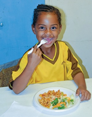 Neizariah Wilson Jones' smile shows how much she enjoys the nutritious meals served at the after-school program