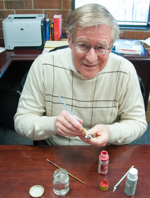 Norman Cuthbert at work. “Final painting commences once the primer seal coat is dry. I paint from the flesh tones out to the final uniform details such as the cuffs”