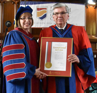 Commissioner Susan McMillan presents Dr. Donald Burke with the Salvation Army's Certificate in Recognition of Exceptional Service