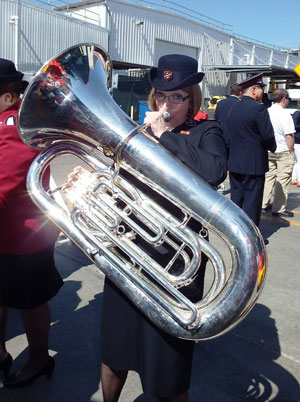 Commissioner Susan McMillan plays a tuba