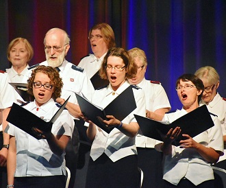 A massed chorus leads the congregation in the singing of Storm the Forts