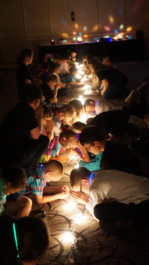 Kids participate in the Glow in the Dark children's church program during the Sunday meeting