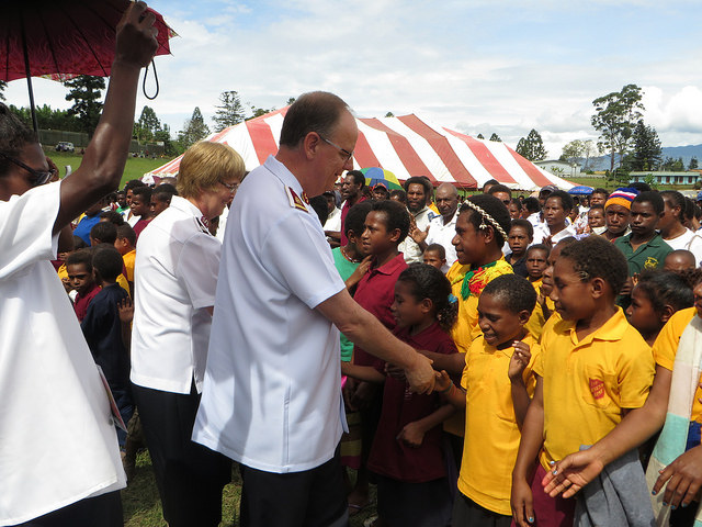 The General and Commissioner Cox greet local children