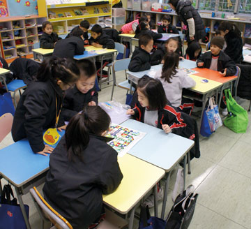 Photo of students in classroom learning to play board games