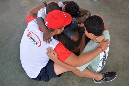 Lieutenant Juan Chirinos prays a prayer of faith with a group of boys