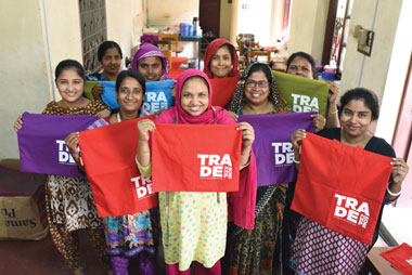 Photo of woman holding bags they produced