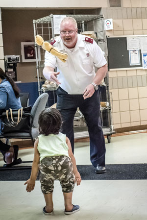 Lt Mark Young plays a game of toss with Ameer Alkhefib