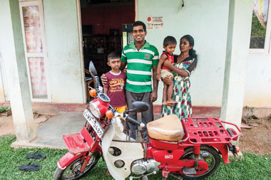 The tsunami swept away tens of thousands of homes and businesses, many of which were poorly constructed. The Salvation Army in Canada and Bermuda, in partnership with other territories, was quick to aid in the rebuilding process. A family stands in front of their new home. 