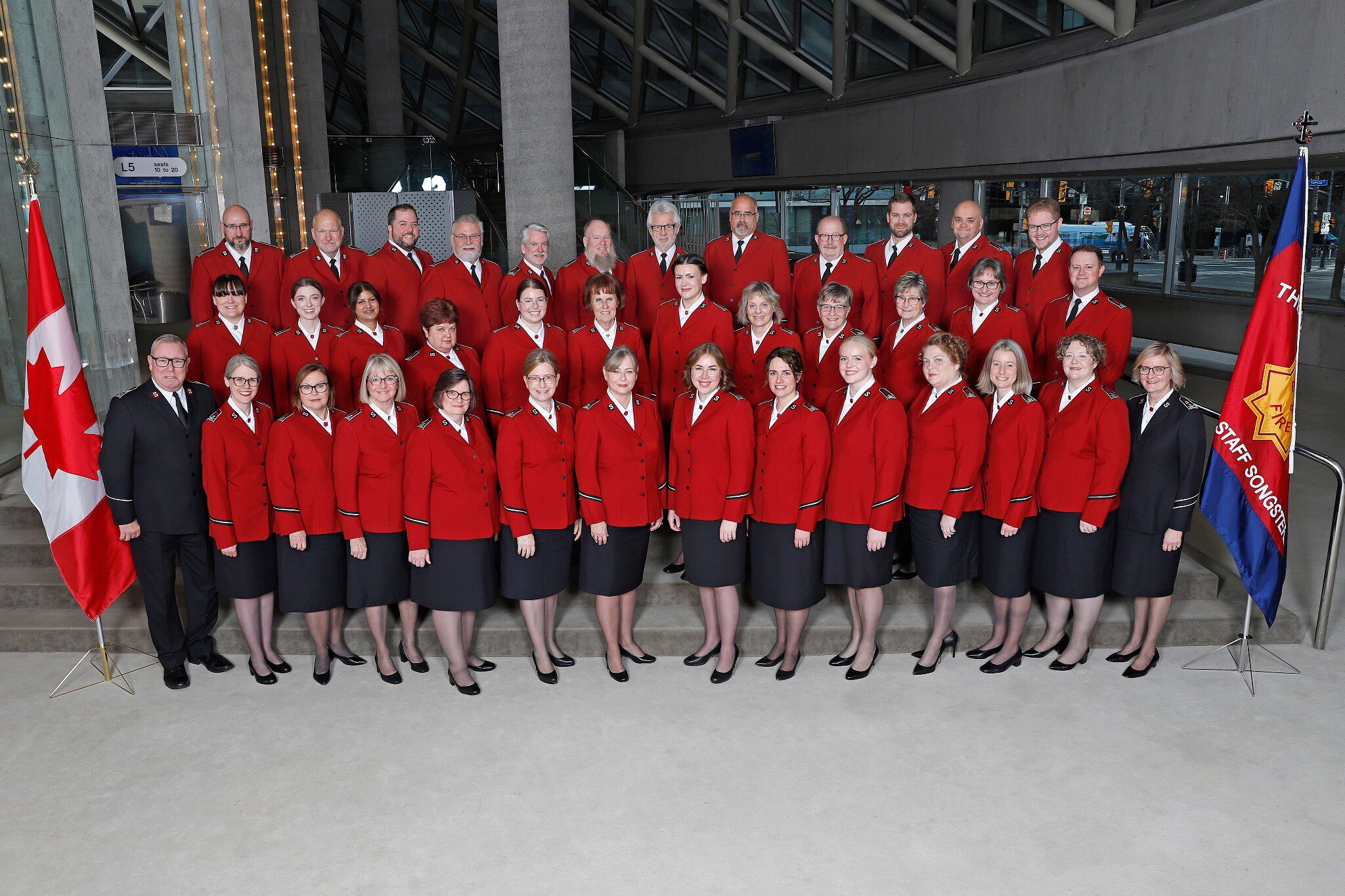 Group photo of the Canadian Staff Songsters at Roy Thompson Hall, December 14, 2024