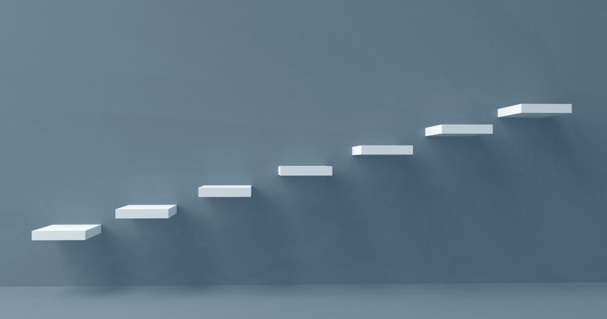 White rectangular floating shelves ascending like a staircase.