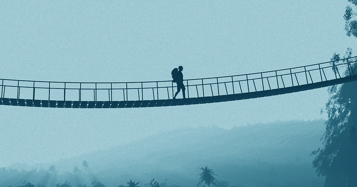 A person walking on a bridge graphic