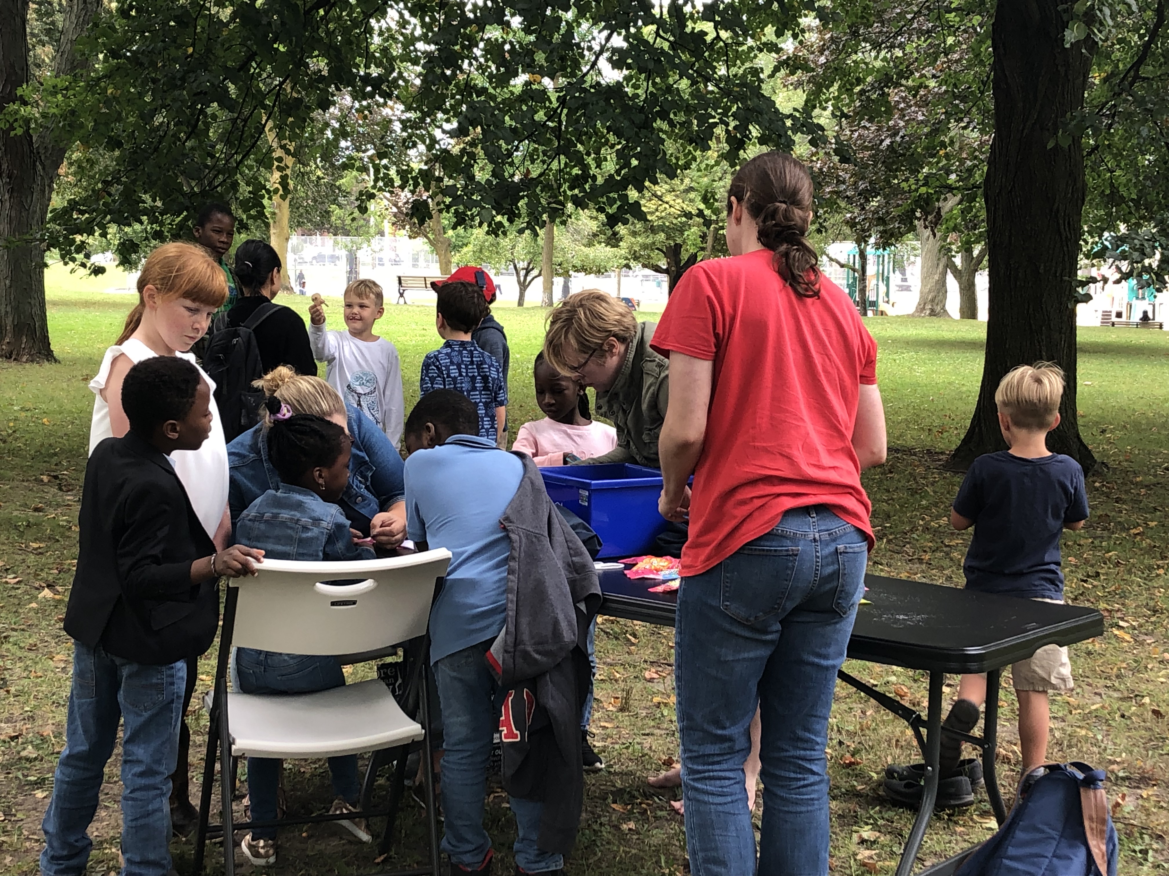 Children gather at the Music in the Park Event for activities and face painting.