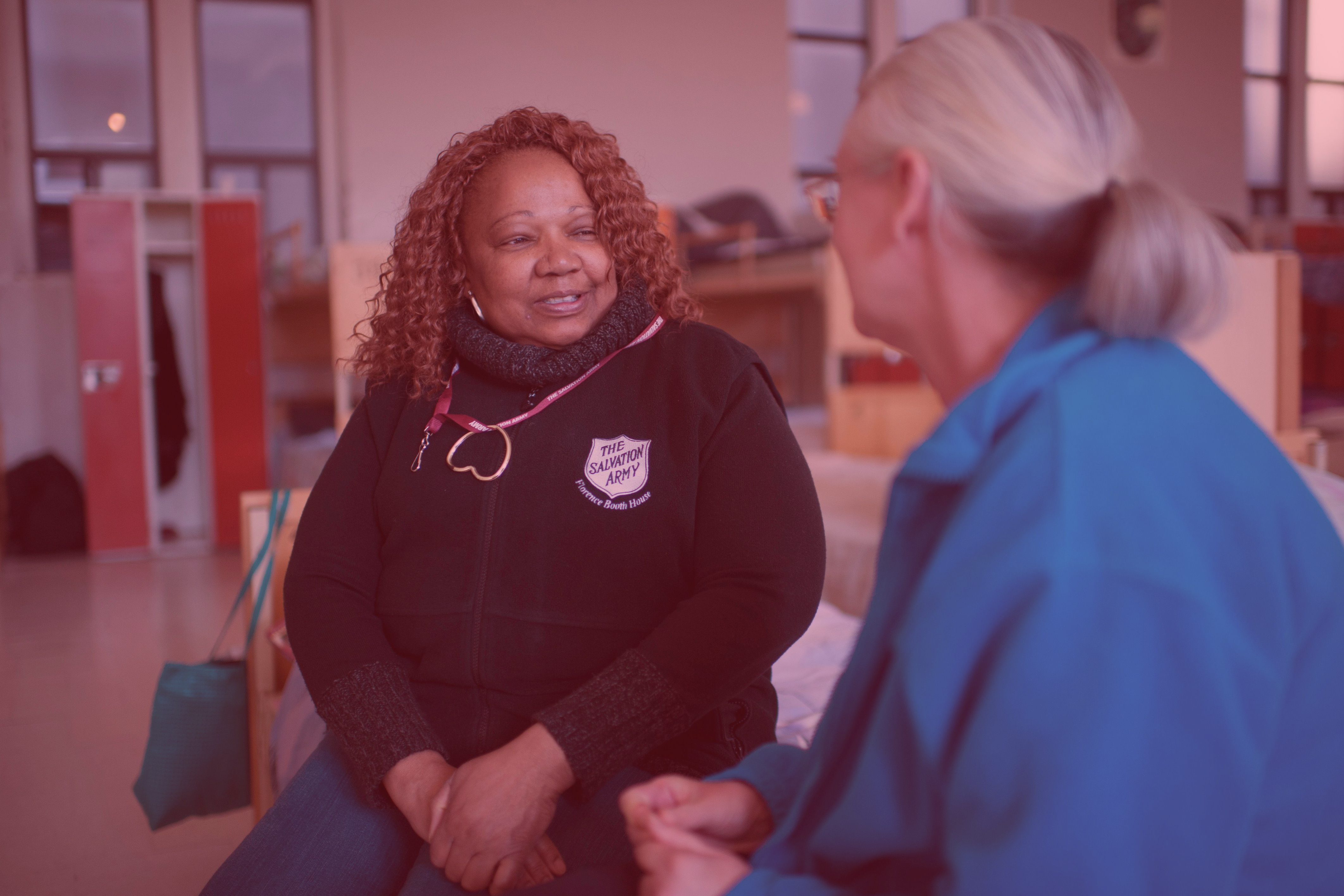 a Salvation Army officer talking to an employee