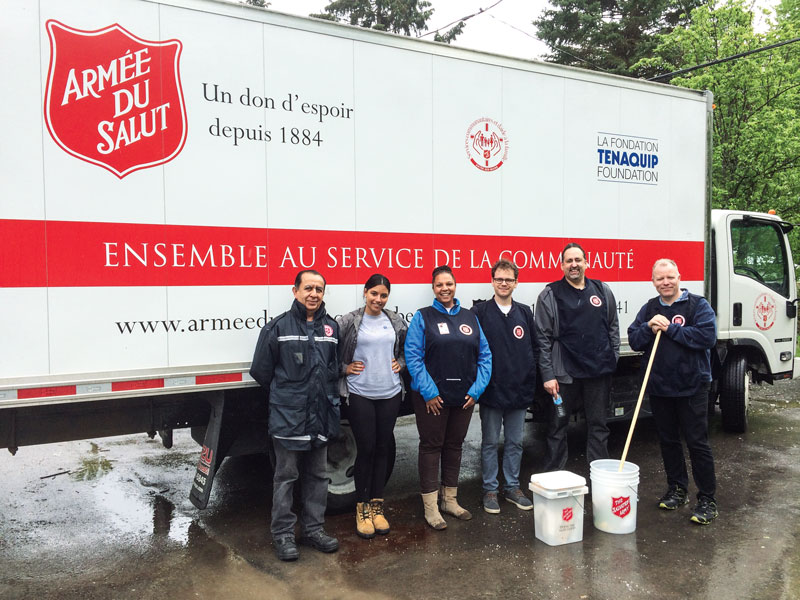 Vanessa Pérugien (centre) and her team deliver clean-up kits to people affected by flooding