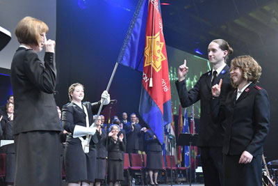 Commissioner Susan McMillan takes the salute from Cadet Brian Dueck and Captain Bethany Dueck at the sending out service