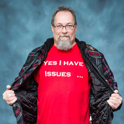 Mark Carlos, wearing a shirt that says, Yes, I have issues