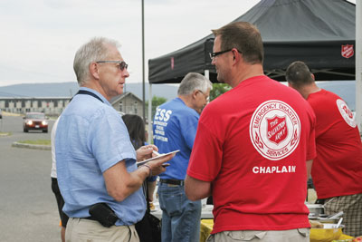 Lt Darryl Burry (right) speaks to Dave Dickson, emergency support services director, in Williams Lake