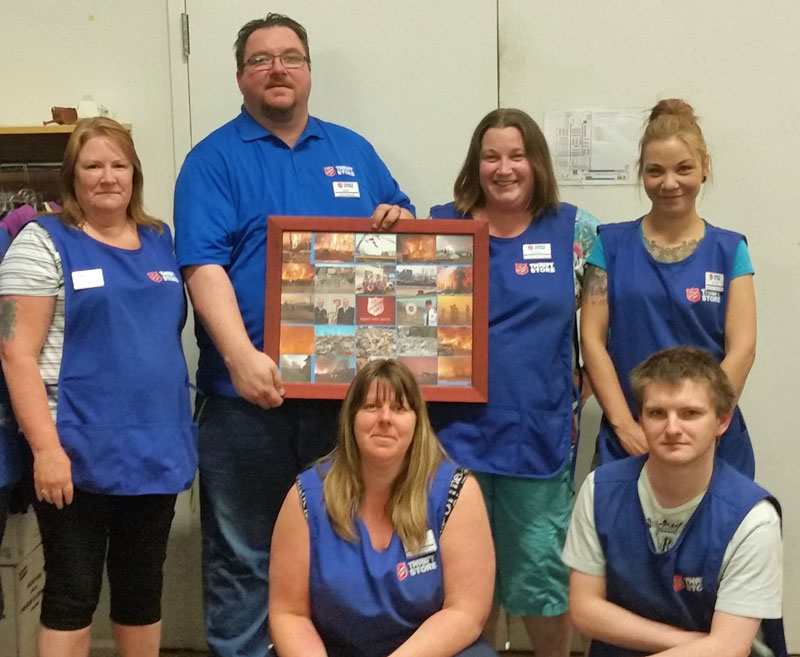 Salvation Army thrift store staff pose with Heather Ryan