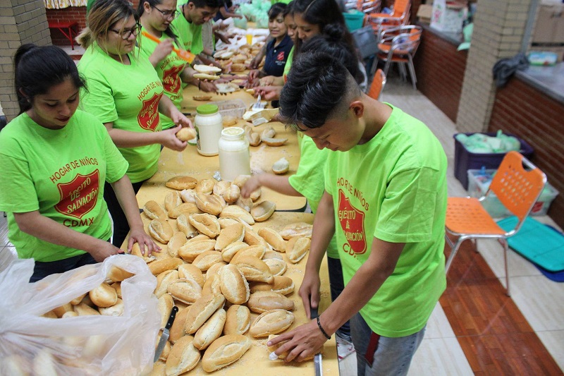 Children of The Salvation Army's Mexico City children's home preparing sandwiches for distribution