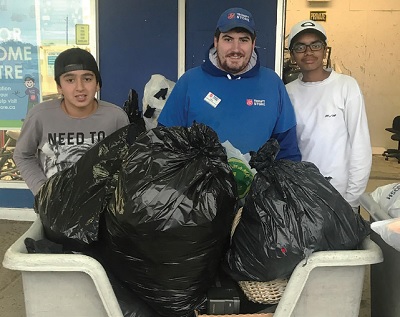 Navid and Santhosh drop off the clothes to a grateful thrift store employee