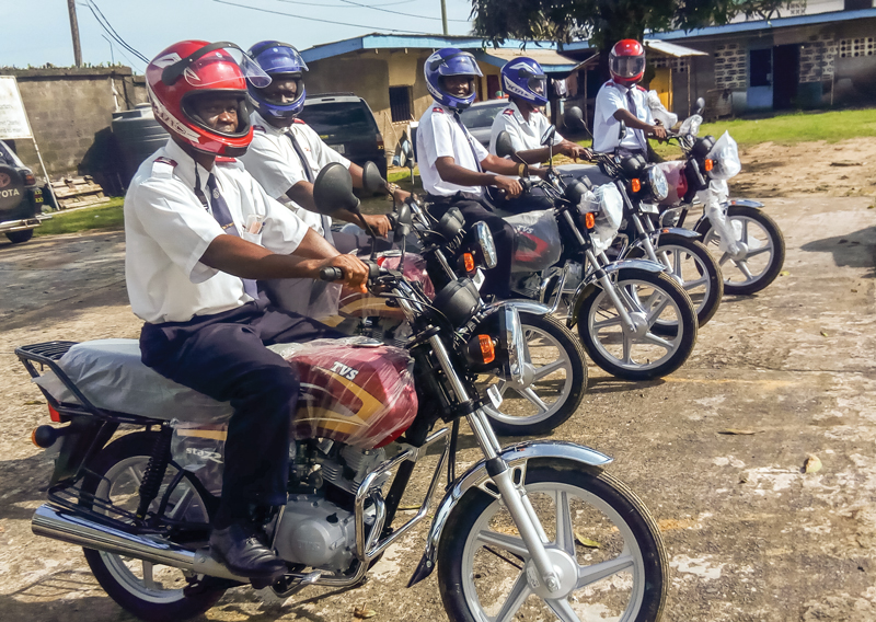 Salvation Army officers at the headquarters of the Liberia Cmd receive donated motorbikes
