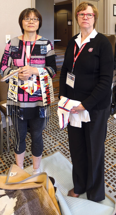 Hua Zhang and Lt-Col Marsha-Jean Bowles participate in the KAIROS blanket exercise