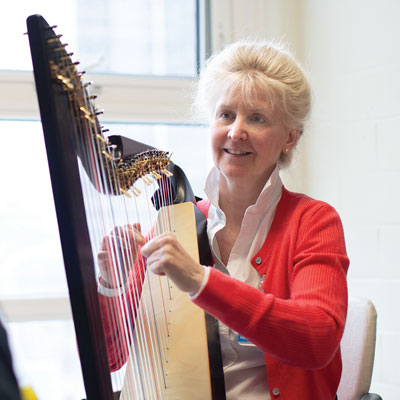 Martha plays the harp