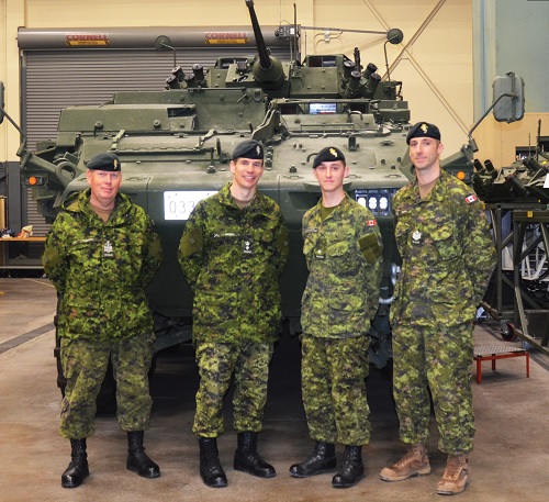 Jeff and soldiers stand by a tank at CFB Borden
