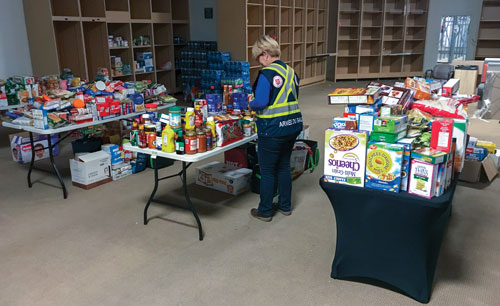 Brigitte St-Germain, DSPRD, Que. Div, sorts donations at a distribution centre in Gatineau, Que.