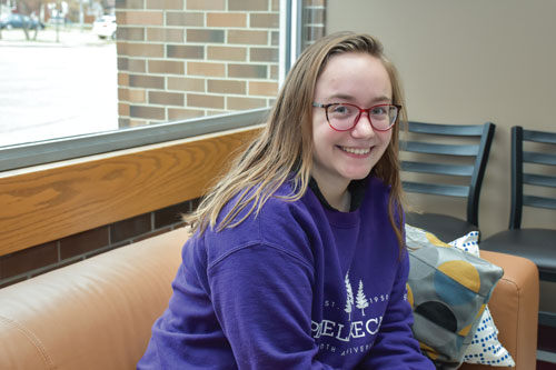 Megan Diamond sitting on a couch at Booth University College