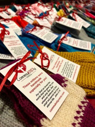 CommuKNITy Cares scarves with handwritten notes attached