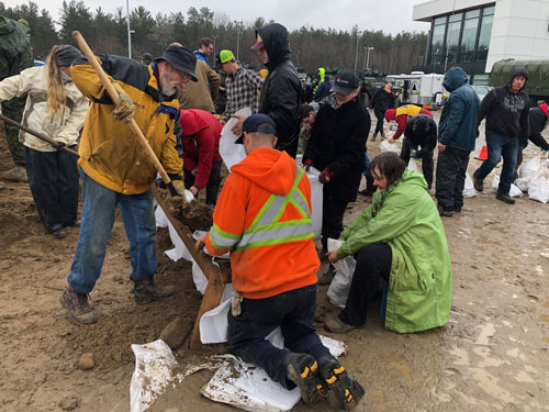Volunteers work together to make sandbags in Ottawa