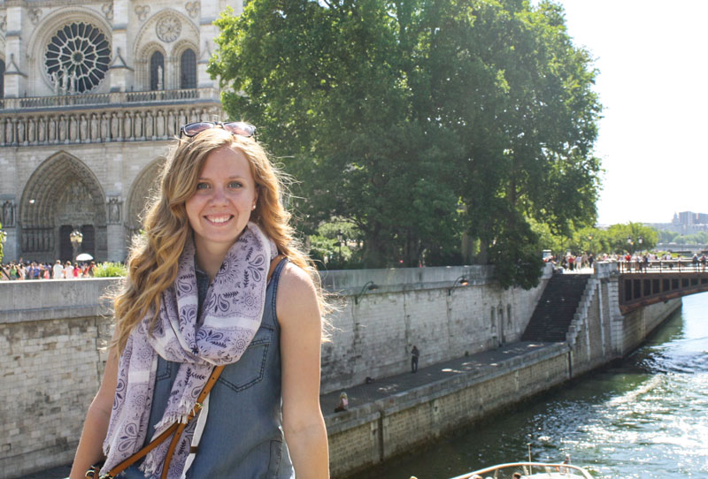 Rebekah Tillsley smiles in front of an old church