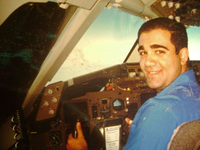 Tharwat Eskander poses inside a Delta Airlines cockpit
