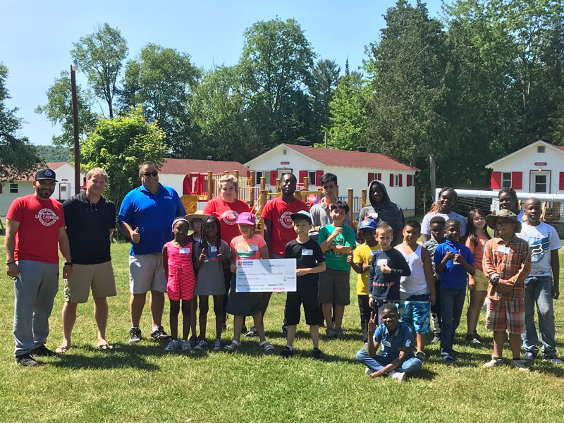 Staff and campers at the Army’s Lac l’Achigan camp in Quebec receive a cheque from NRO