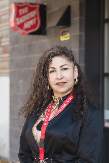 Beatriz Alvaran, with a Salvation Army shield in the background