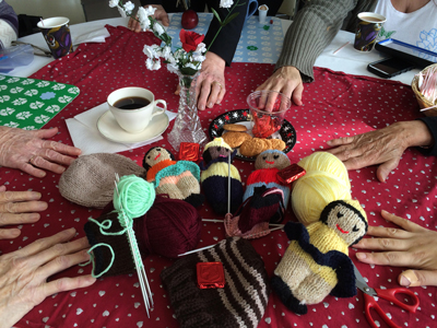 Photo of table with coffee, treats and knitting