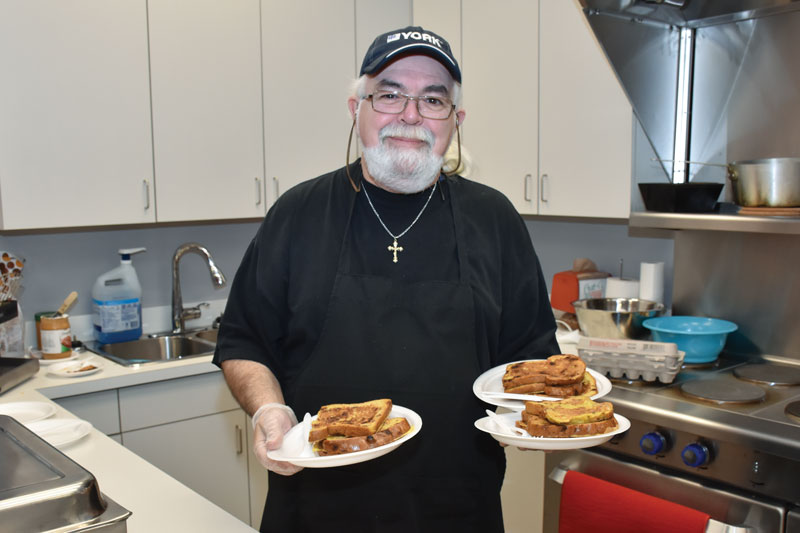 Robert Mombourquette cooks and serves French toast at The Gathering Place (Photos: Kristin Ostensen)