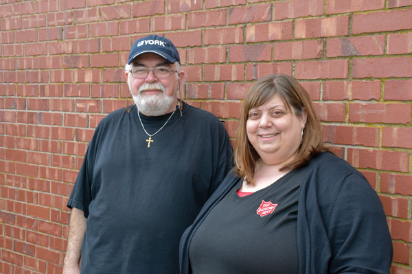 Robert Mombourquette and Natasha Burkett stand by a brick wall