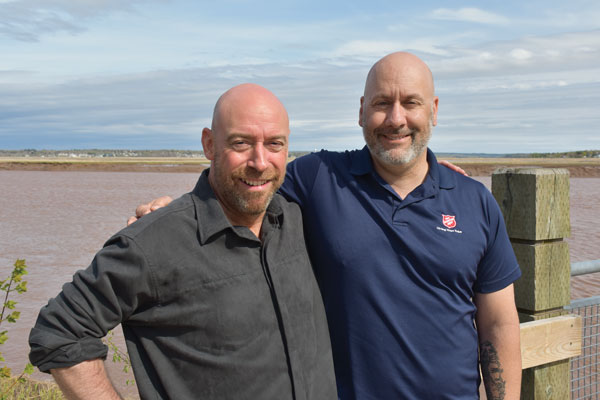 Mark Melanson and Todd Benoit share a moment at the Petitcodiac River