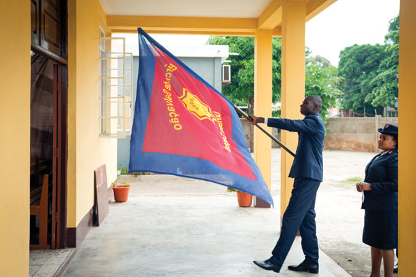 A man carries a Salvation Army flag into a church building