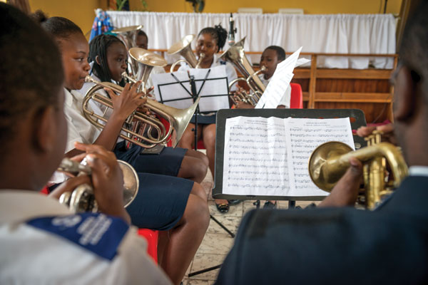 Young people play brass instruments