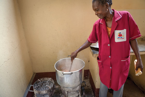 A woman cooks food in a pot
