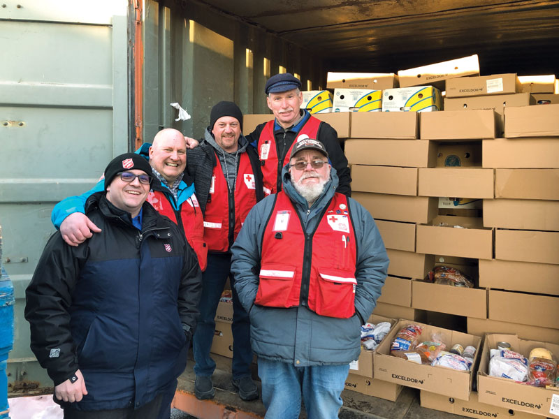 Mjr Corey Vincent and members of the Red Cross distribute food for Christmas