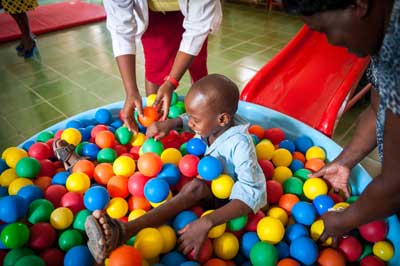 Photo of child playing with balls