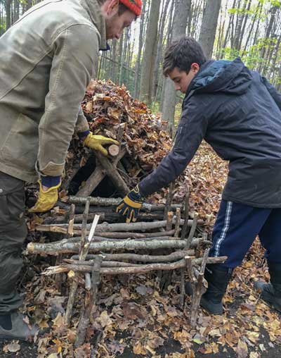 Learning to make a wilderness survival shelter