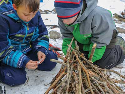 Building a fire on a winter camping trip