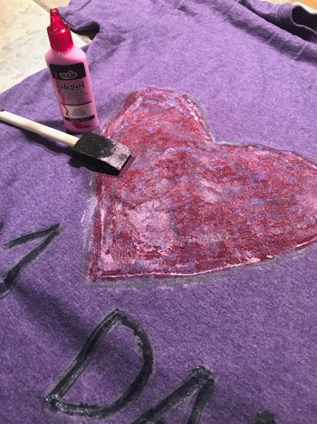 Purple T-shirt with heart painted on it